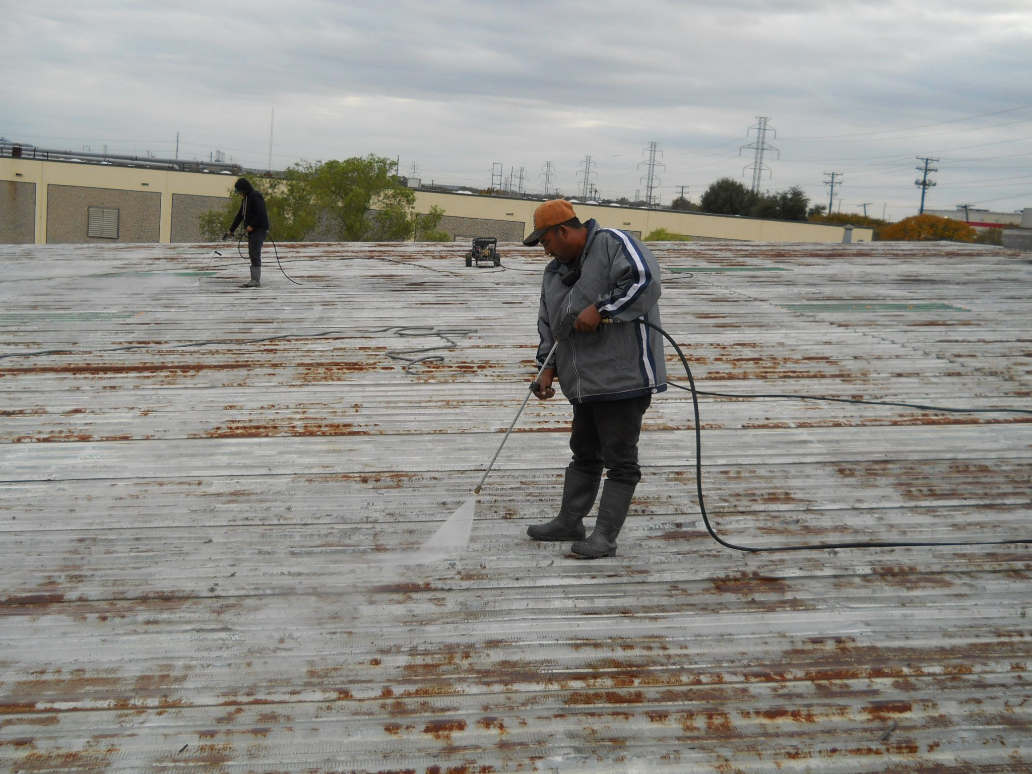 Metal Roof Coating being Installed - Nelson Roofing Company